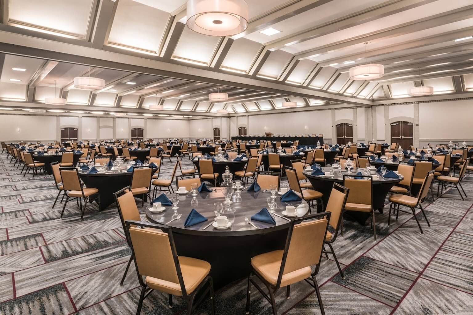 Large conference room with circular tables set for a meal