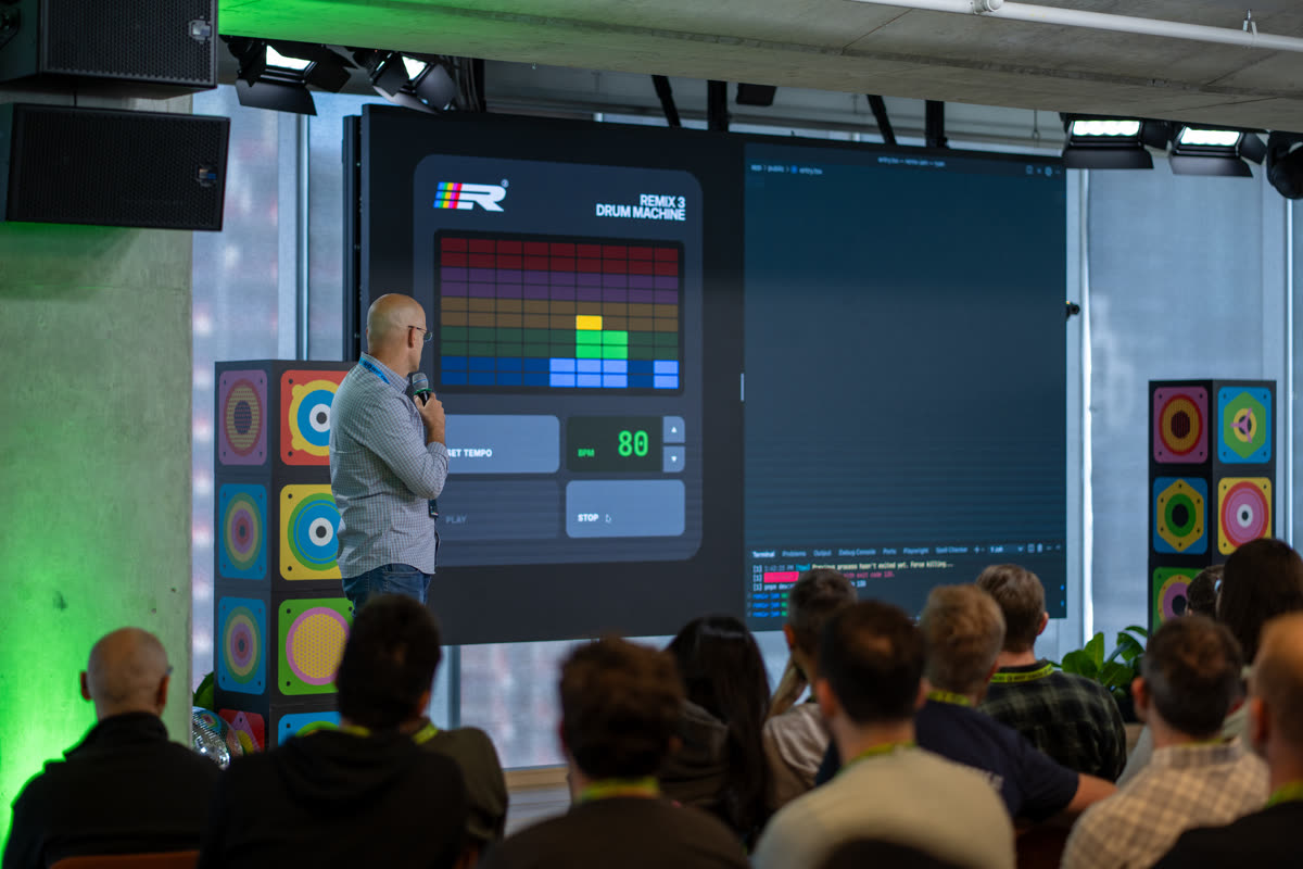 A speaker demonstrates the Remix 3 Drum Machine to attendees at Remix Jam 2025